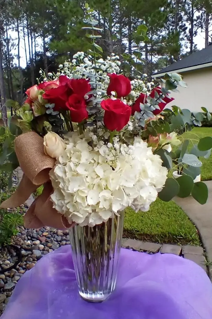 Mother's Day floral arrangement featuring red roses and white flowers. Mother's Day floral arrangement featuring red roses and white flowers.