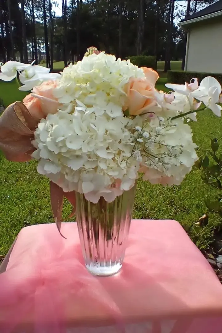 Mother's Day floral arrangements featuring pink roses white orchids. Mother's Day floral arrangements featuring pink roses white orchids.