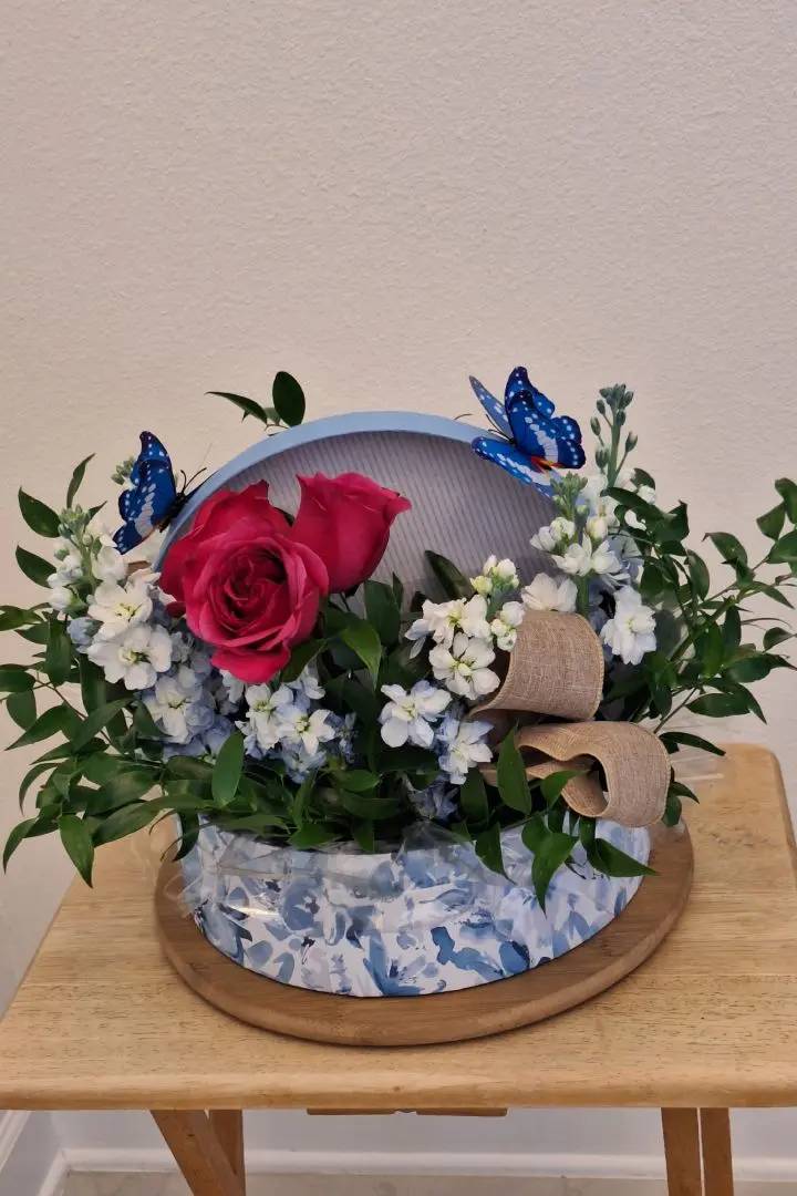 Mother's Day floral arrangement, featuring pink roses and white roses in a decorative box container with butterfly decorations, designed by Lorraine for a customer in Jacksonville, FL Mother's Day floral arrangement, featuring pink roses and white roses in a decorative box container with butterfly decorations, designed by Lorraine for a customer in Jacksonville, FL