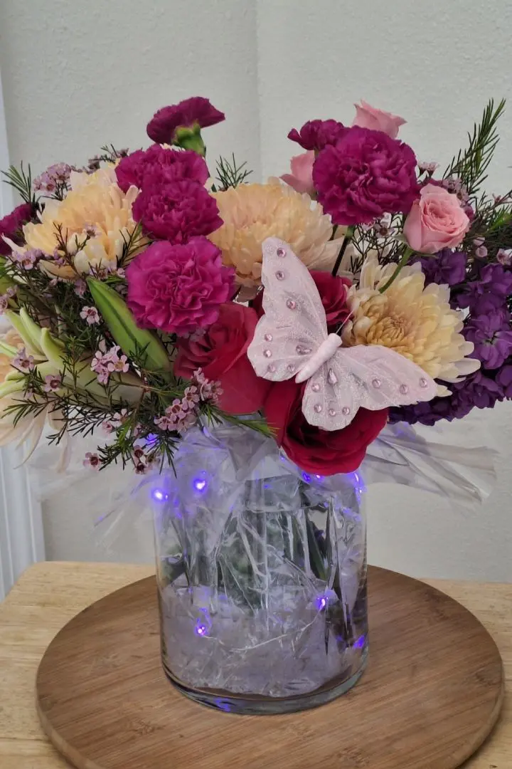 Mothers Day floral arrangement featuring pink and white carnations pink roses in lighted vase, designed by Lorraine for Mothers Day in Oakleaf Plantation, FL Mothers Day floral arrangement featuring pink and white carnations pink roses in lighted vase, designed by Lorraine for Mothers Day in Oakleaf Plantation, FL